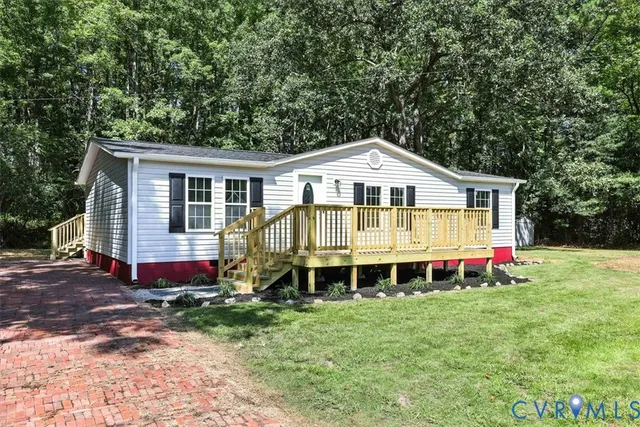 a front view of a house with a yard and balcony