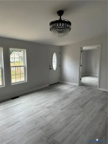 a view of an empty room and a window