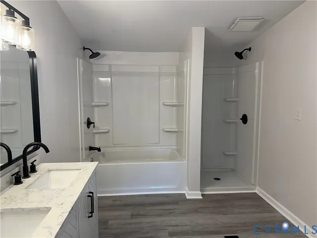 a bathroom with a granite countertop sink mirror and shower