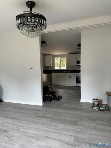 a kitchen with kitchen island a stove and a wooden floor