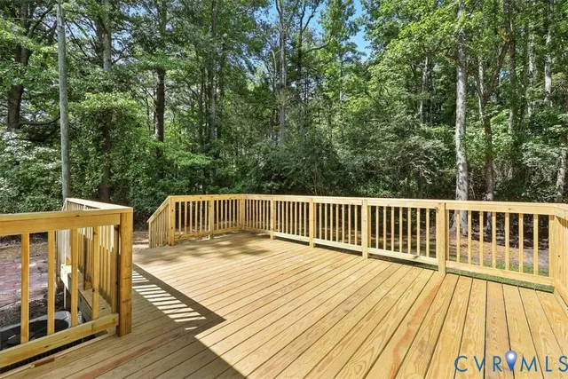 a balcony with wooden floor and fence
