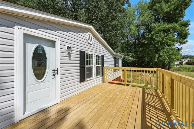 a view of a balcony with wooden floor and fence