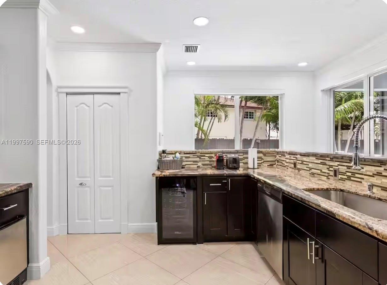 15411 Southwest 36th Terrace Miami, FL 33185 - Photo 11 of 45 a kitchen with a sink stove and cabinets