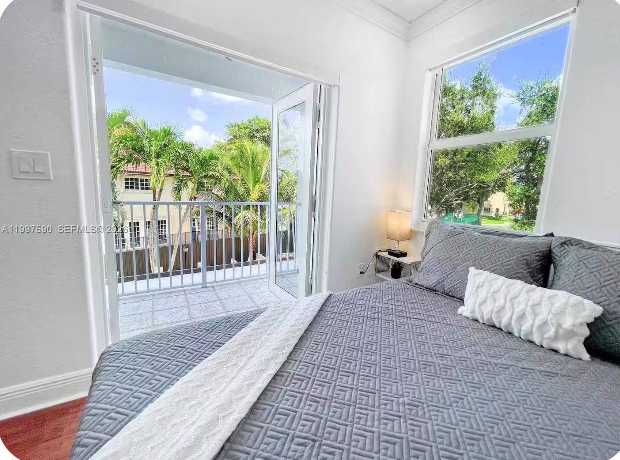 15411 Southwest 36th Terrace Miami, FL 33185 - Photo 15 of 45 a bedroom with furniture and a large window