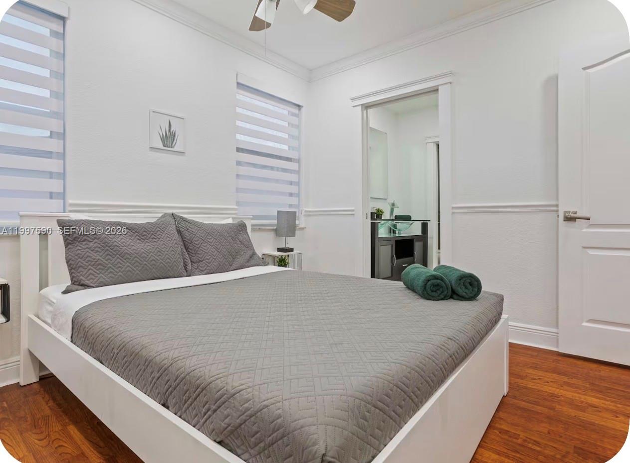 15411 Southwest 36th Terrace Miami, FL 33185 - Photo 20 of 45 a bedroom with a bed and wooden floor