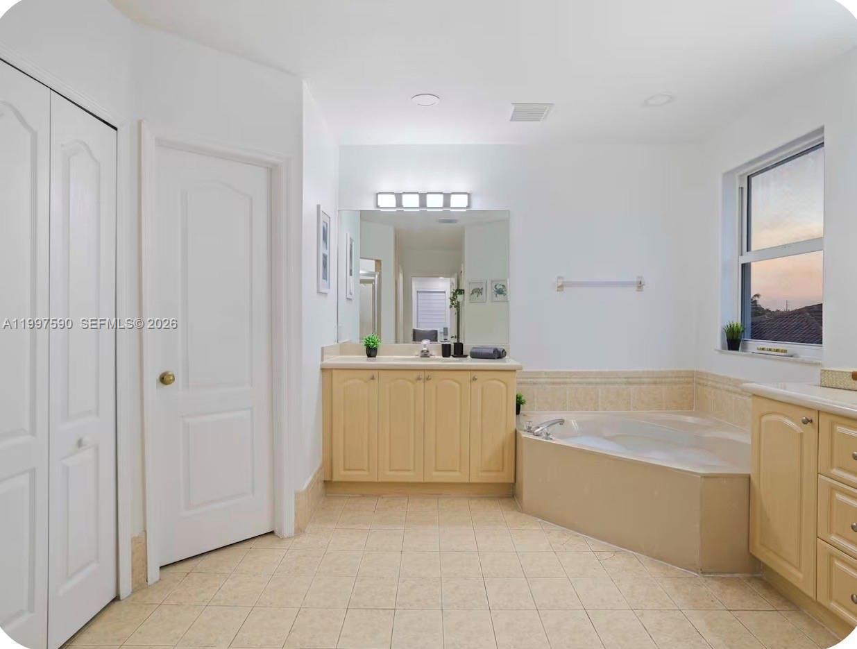 15411 Southwest 36th Terrace Miami, FL 33185 - Photo 22 of 45 a bathroom with a tub a sink and a mirror
