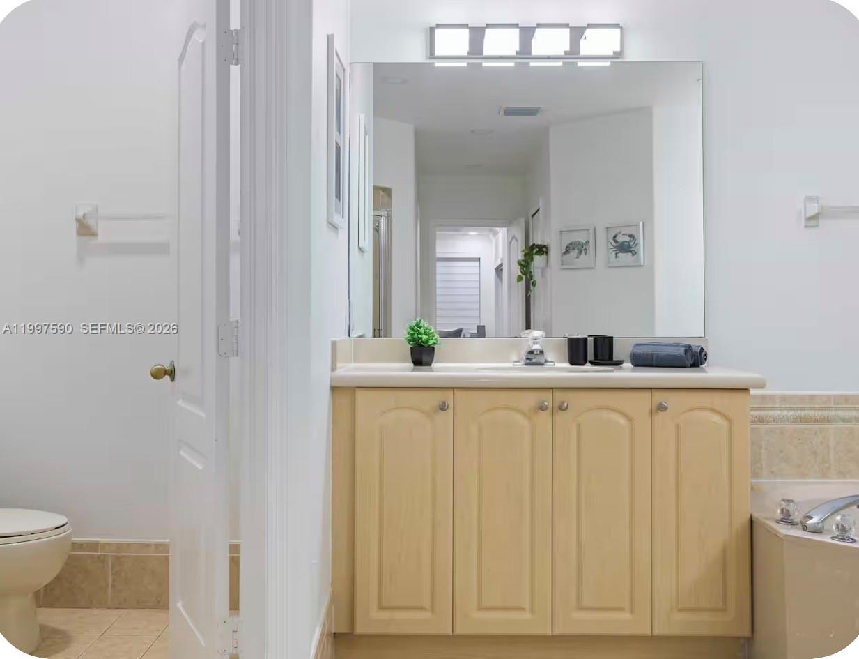 15411 Southwest 36th Terrace Miami, FL 33185 - Photo 25 of 45 a bathroom with a sink vanity mirror and toilet