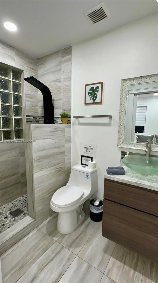 15411 Southwest 36th Terrace Miami, FL 33185 - Photo 27 of 45 a bathroom with a toilet sink and mirror