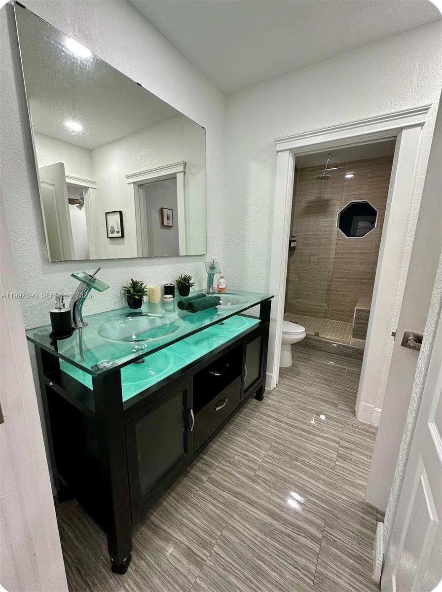 15411 Southwest 36th Terrace Miami, FL 33185 - Photo 29 of 45 a bathroom with sink and mirror