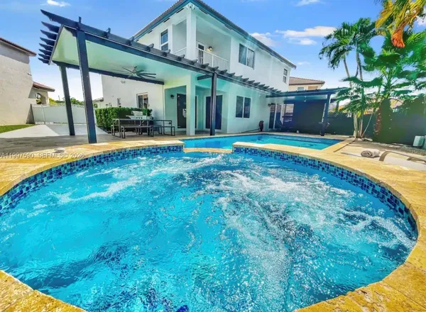 a view of a house with swimming pool and a porch