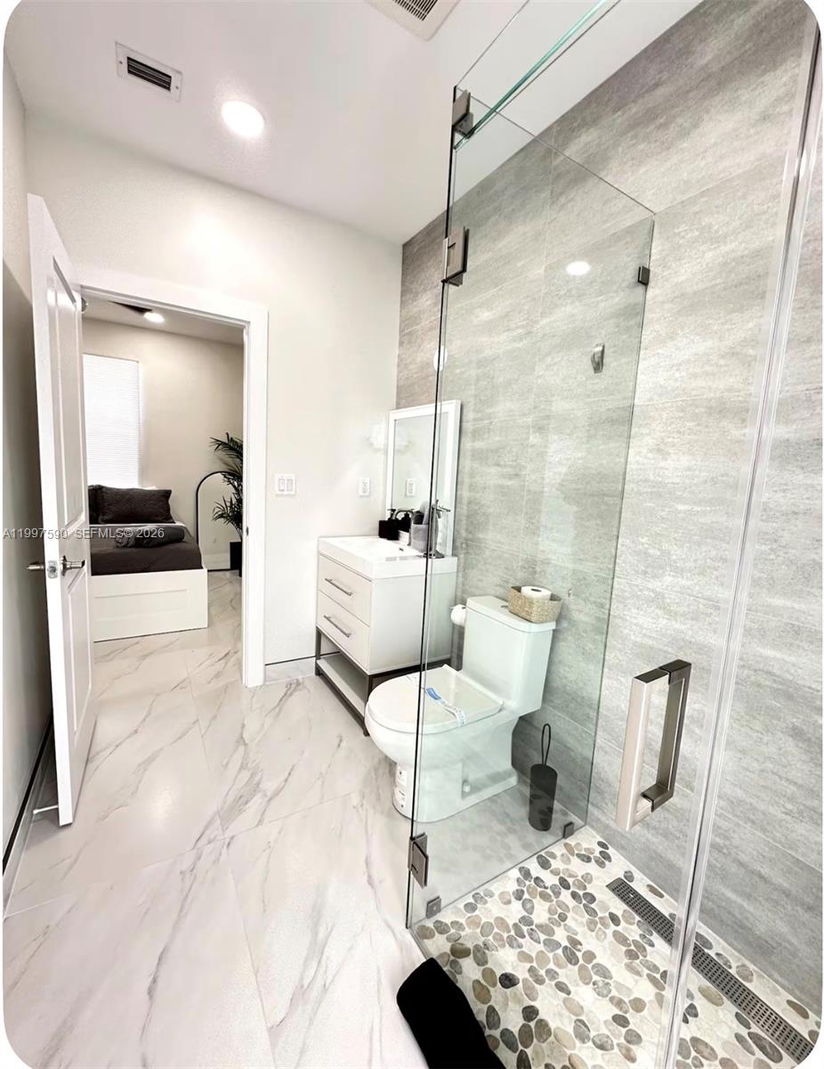 15411 Southwest 36th Terrace Miami, FL 33185 - Photo 31 of 45 a bathroom with a sink toilet and shower