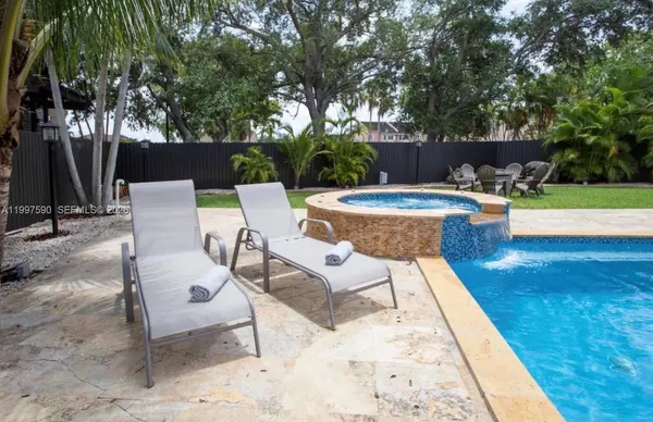 a view of a backyard with sitting area