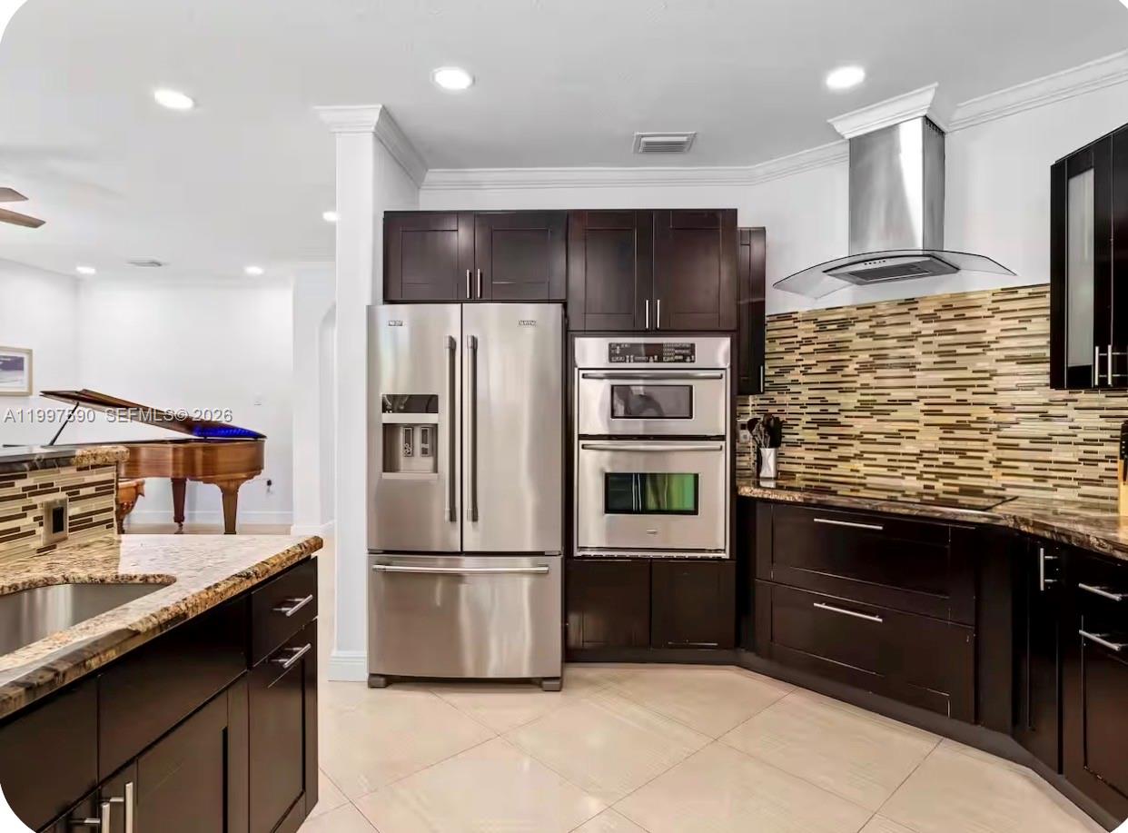 15411 Southwest 36th Terrace Miami, FL 33185 - Photo 9 of 45 a kitchen with stainless steel appliances kitchen island granite countertop a refrigerator and a sink