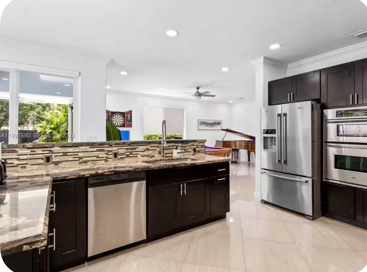 15411 Southwest 36th Terrace Miami, FL 33185 - Photo 10 of 45 a kitchen with stainless steel appliances granite countertop a stove a refrigerator and a sink
