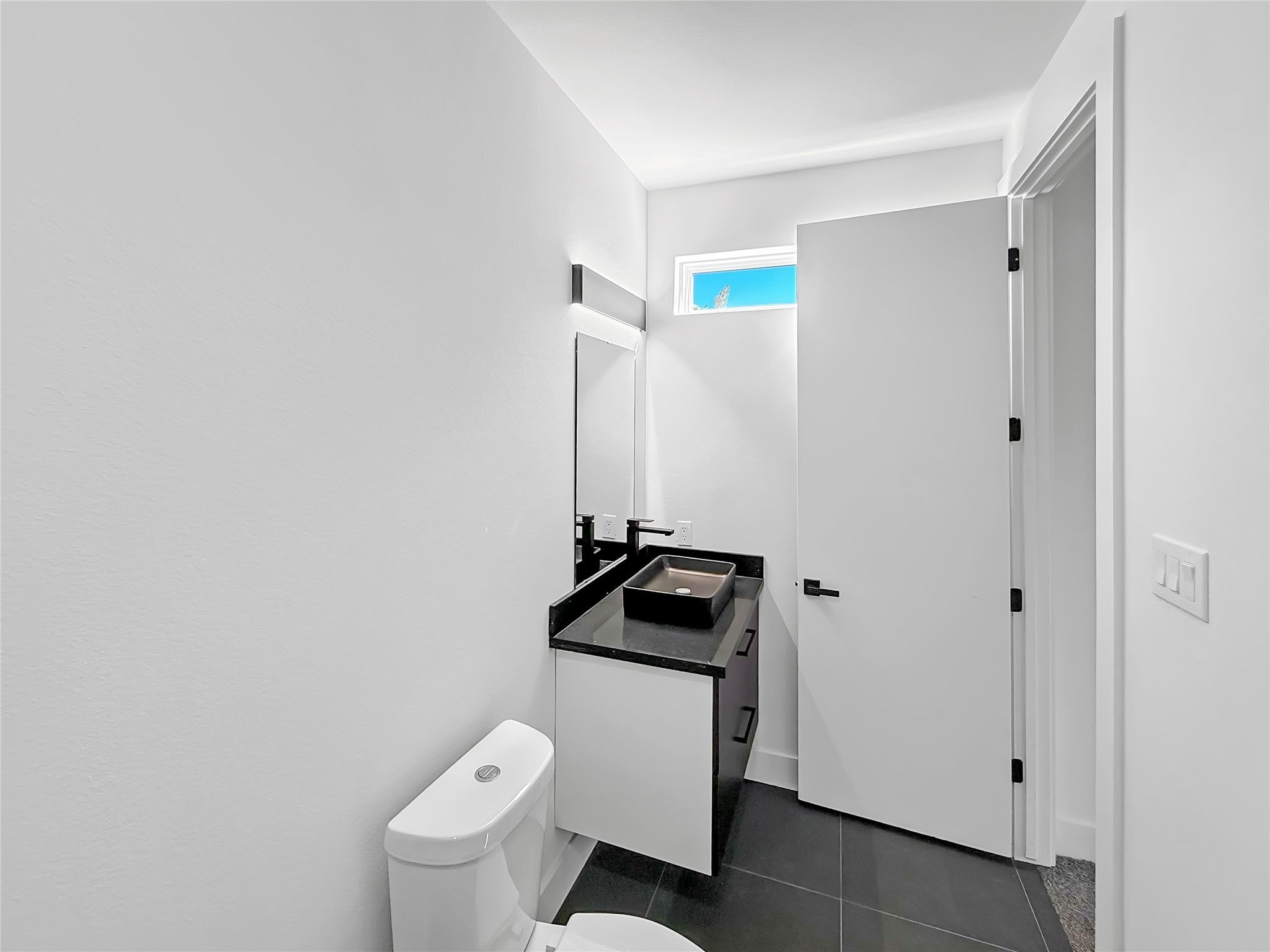 3115 Evella Street Houston, TX 77026 - Photo 18 of 21 a bathroom with a granite countertop toilet and sink