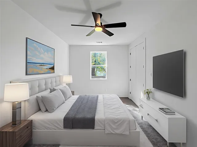 a bedroom with a bed and a flat screen tv