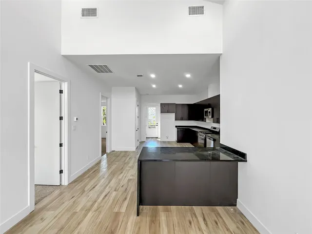 a view of kitchen with kitchen island microwave and stove