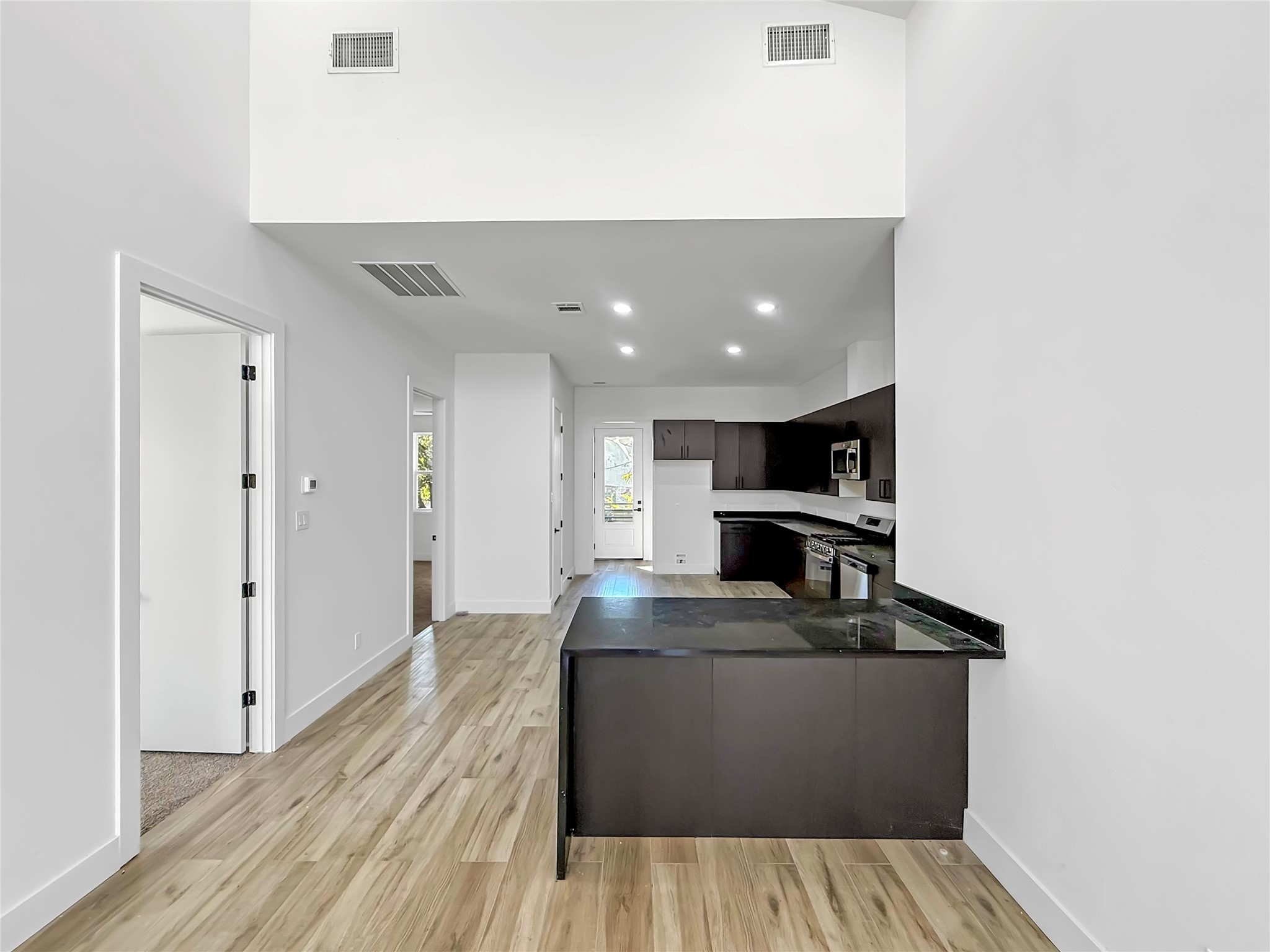 3115 Evella Street Houston, TX 77026 - Photo 9 of 21 a view of kitchen with kitchen island microwave and stove