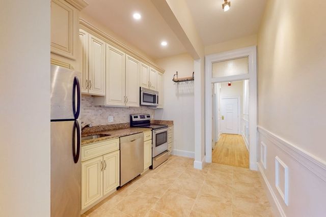 a kitchen with cabinets and appliances