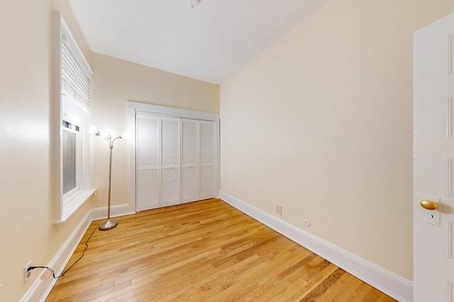 a view of a room with wooden floor and brick walls