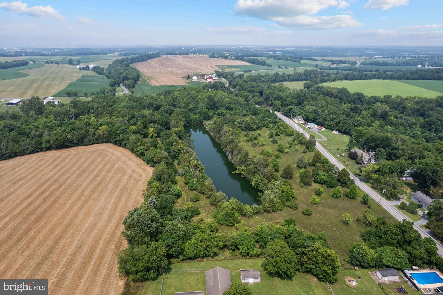 an aerial view of a house with a yard and lake view