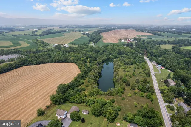 an aerial view of a houses with a yard
