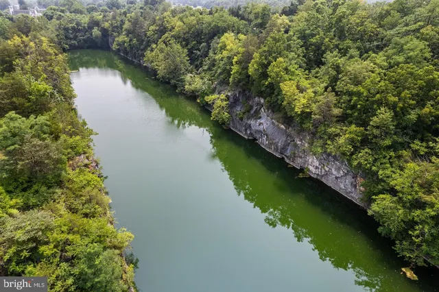 an aerial view of a house with a yard and lake view