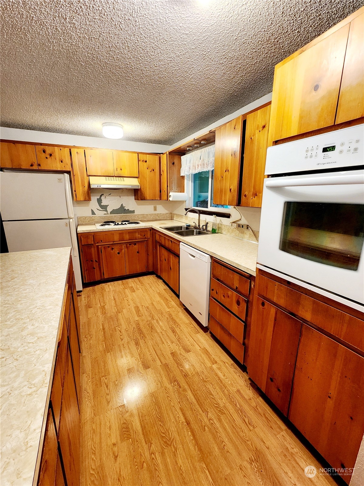15 Foreman Road McCleary, WA 98557 - Photo 11 of 31 a large kitchen with a stove a sink and a refrigerator