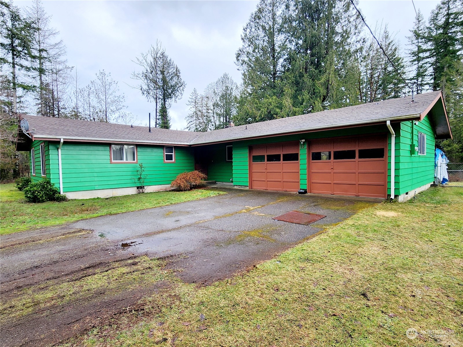 15 Foreman Road McCleary, WA 98557 - Photo 4 of 31 a front view of a house with a yard and garage