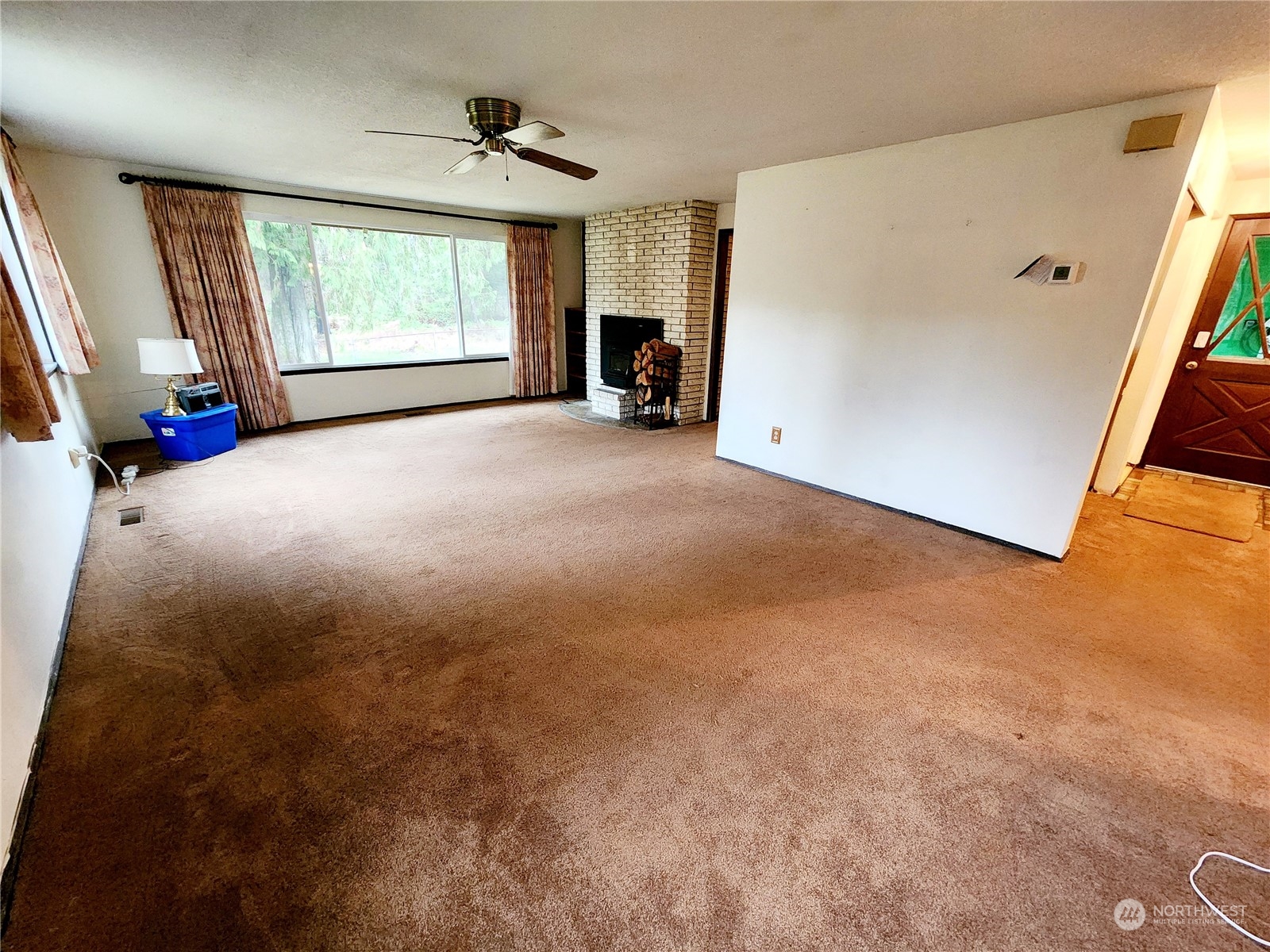 15 Foreman Road McCleary, WA 98557 - Photo 7 of 31 a view of an empty room with a fireplace and a window