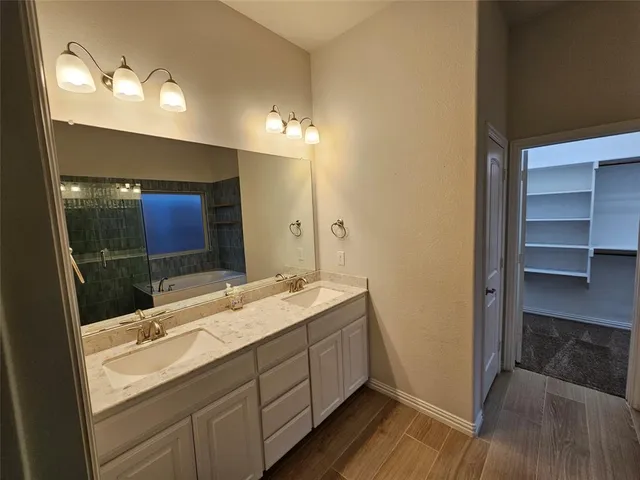 a bathroom with a double vanity sink and a mirror