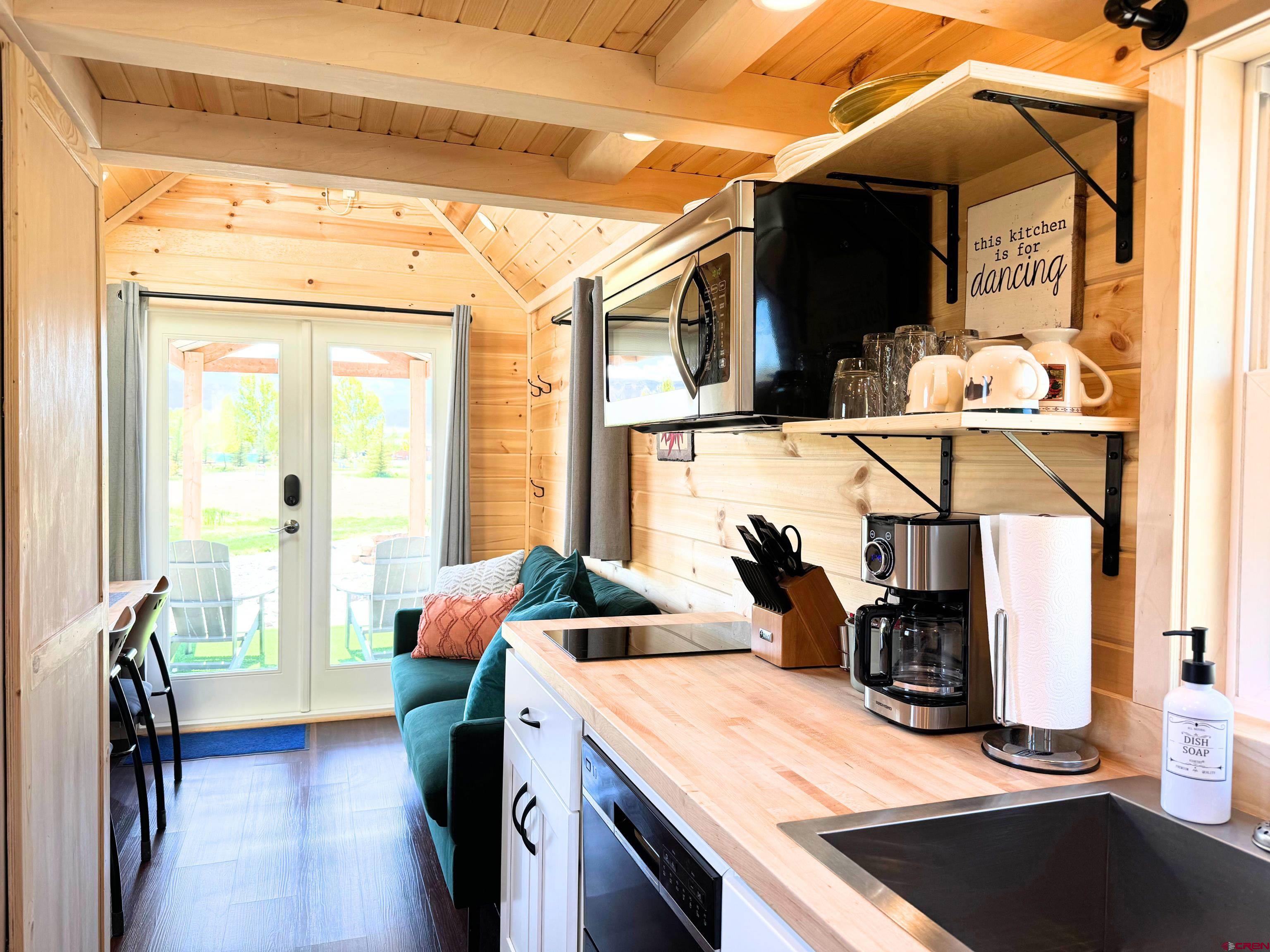 22130 6850 Road, Unit 210215 Montrose, CO 81403 - Photo 13 of 35 a kitchen view of microwave a sink and a stove