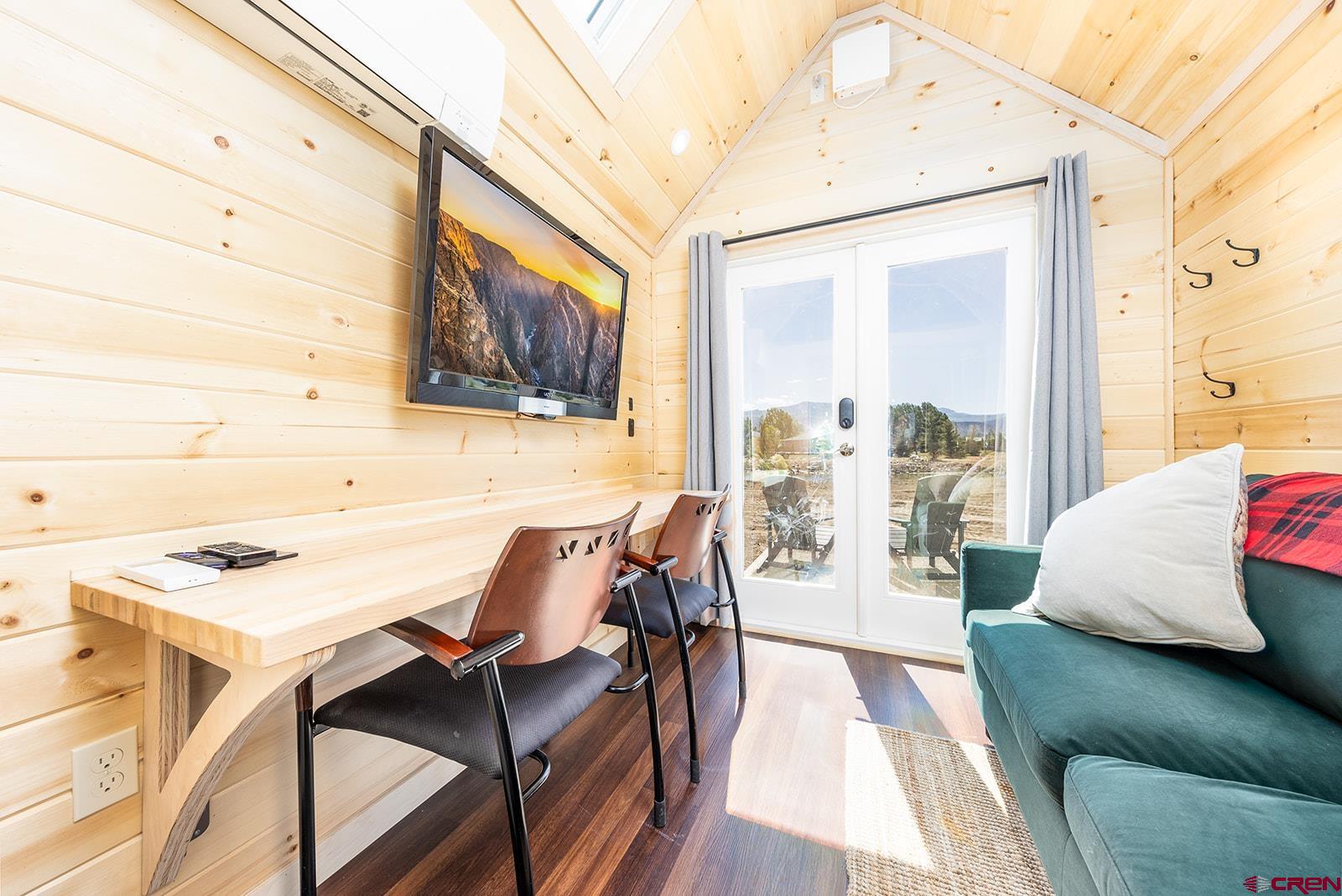 22130 6850 Road, Unit 210215 Montrose, CO 81403 - Photo 19 of 35 a view of a living room with furniture and wooden floor