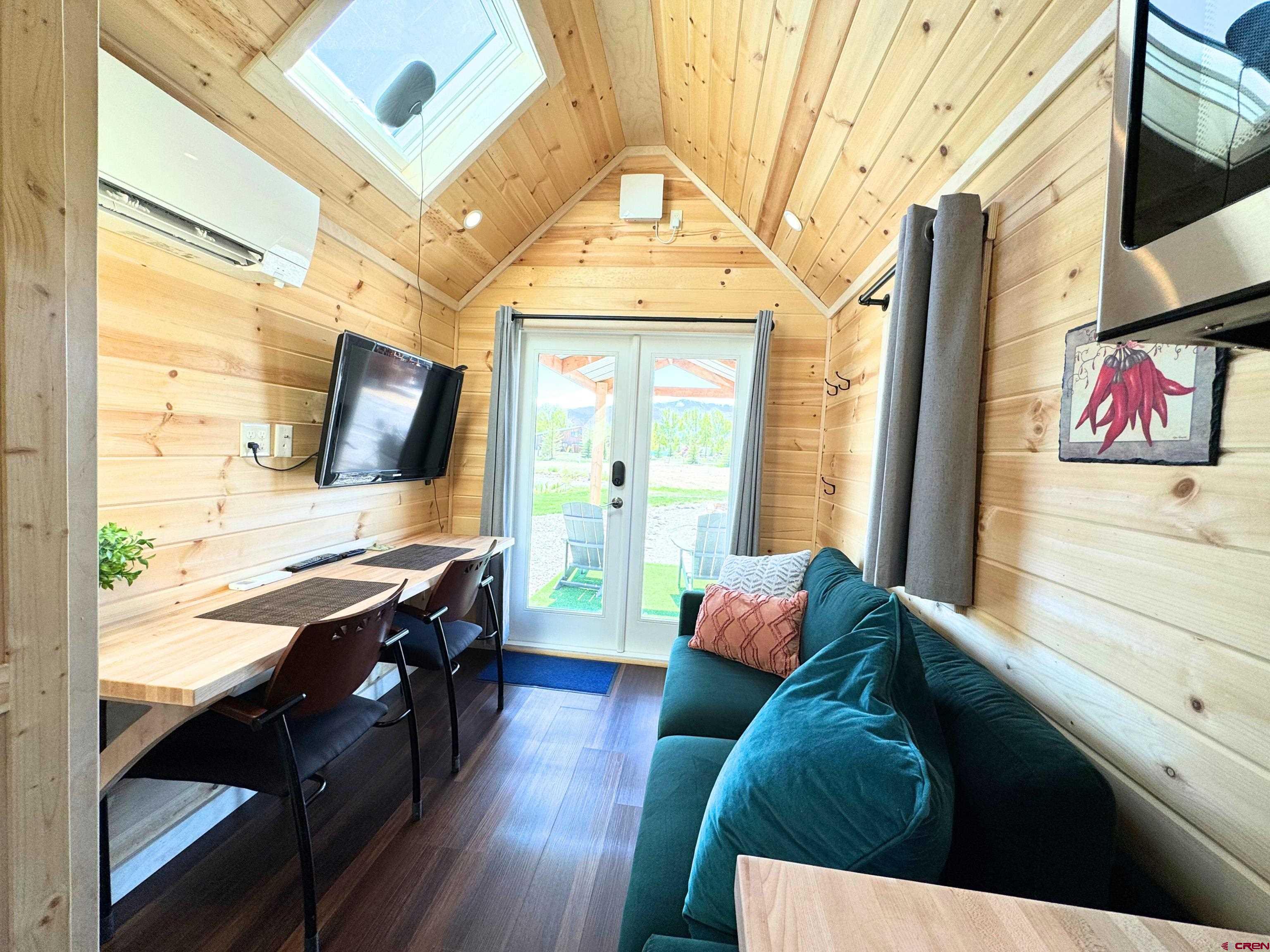 22130 6850 Road, Unit 210215 Montrose, CO 81403 - Photo 21 of 35 a living room with furniture and a flat screen tv