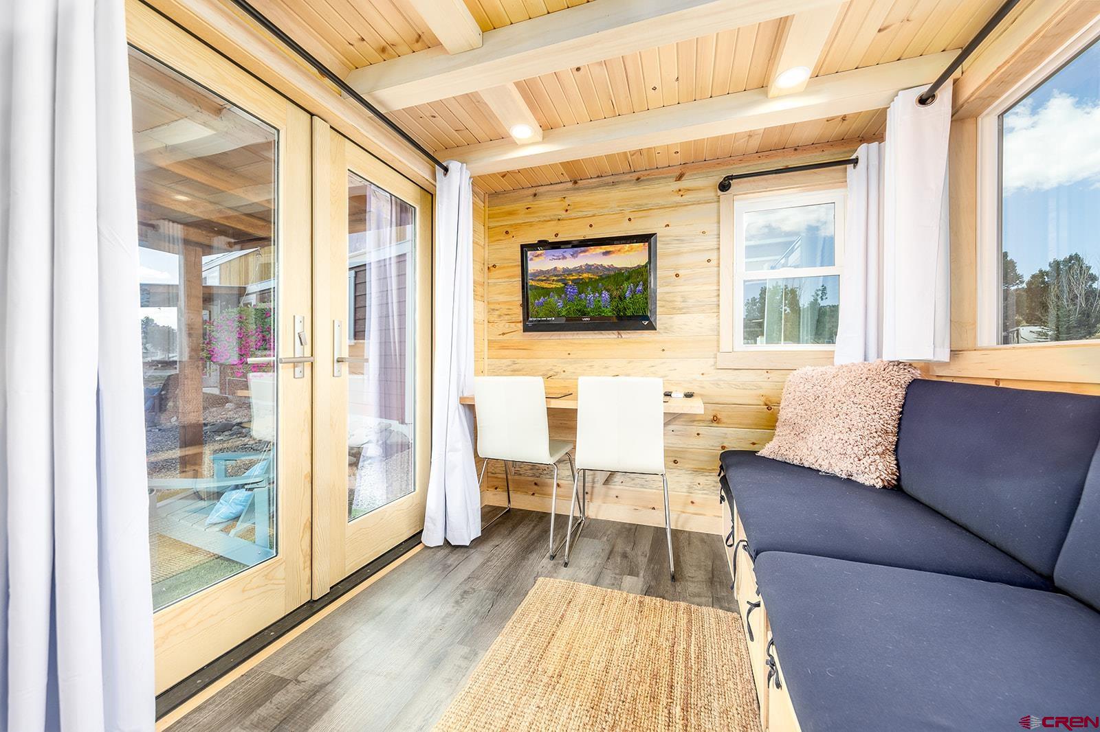 22130 6850 Road, Unit 210215 Montrose, CO 81403 - Photo 23 of 35 a living room with furniture and a flat screen tv