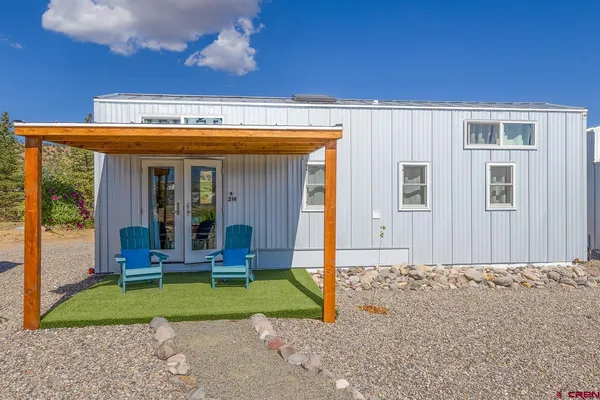a view of a house with backyard porch and garden