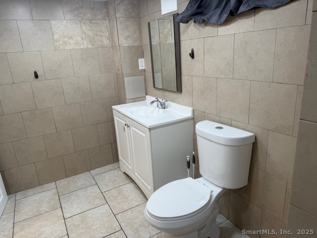 100 South Cliff Street Ansonia, CT 06401 - Photo 13 of 14 a white toilet sitting next to a bathroom sink