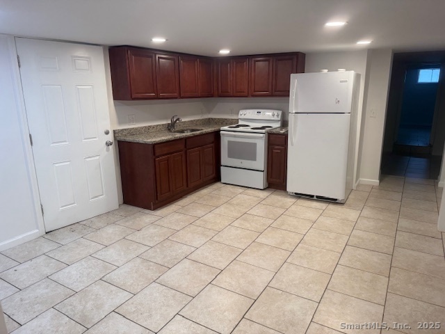 100 South Cliff Street Ansonia, CT 06401 - Photo 4 of 14 a kitchen with stainless steel appliances granite countertop a refrigerator sink and cabinets