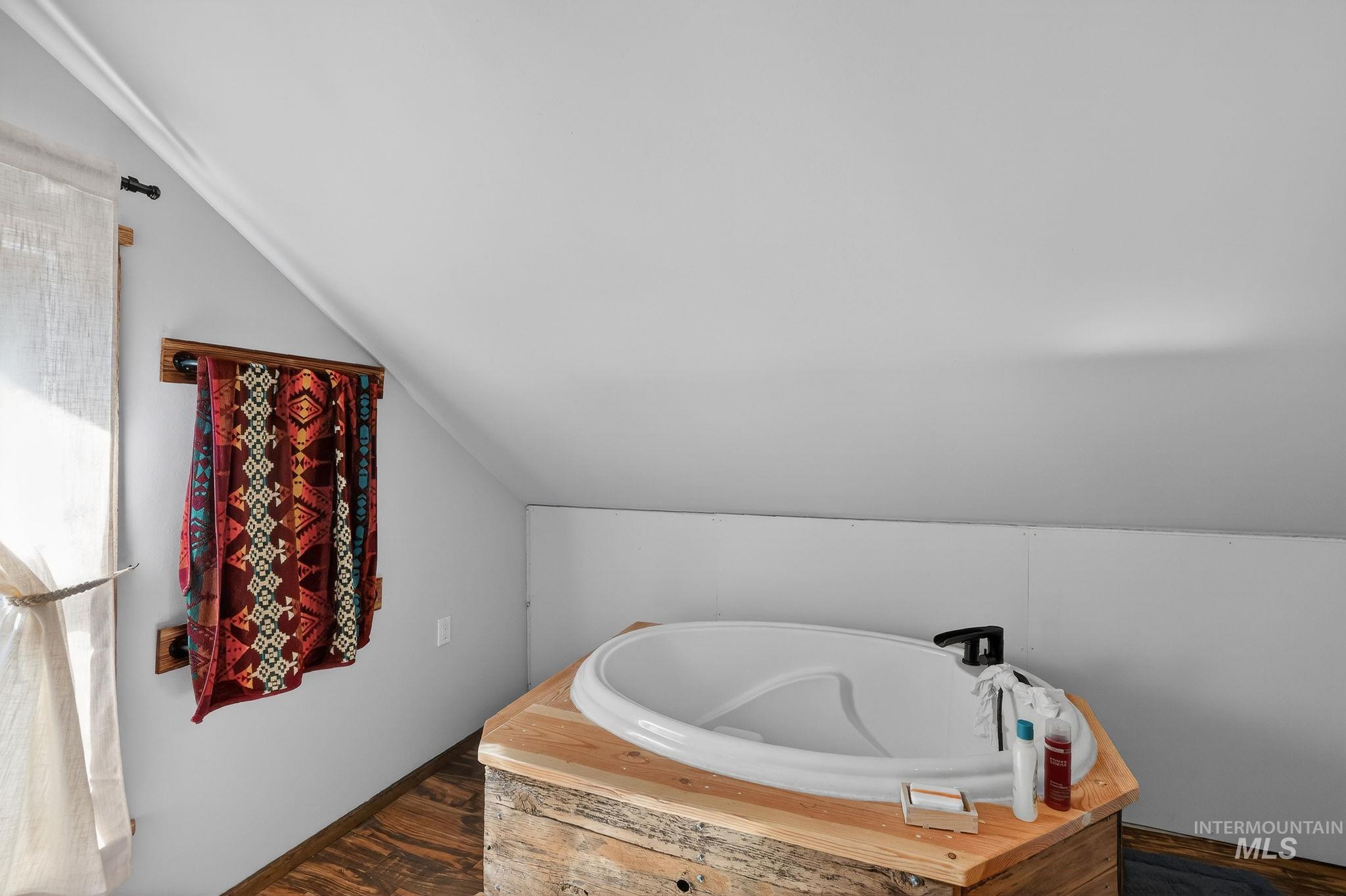 321 Secesh River Road McCall, ID 83638 - Photo 20 of 50 Freestanding soaking tub with a black faucet, set within a custom wood surround