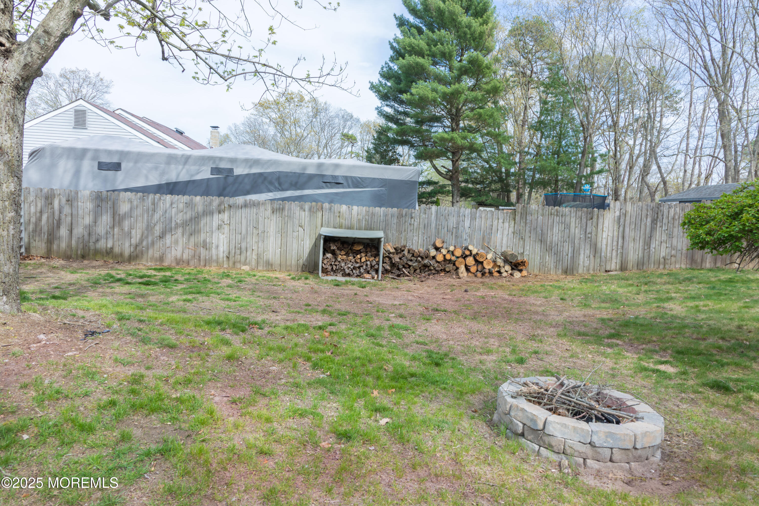 21 Birmingham Drive Jackson, NJ 08527 - Photo 27 of 27 a view of a backyard with table and chairs potted plants and wooden fence