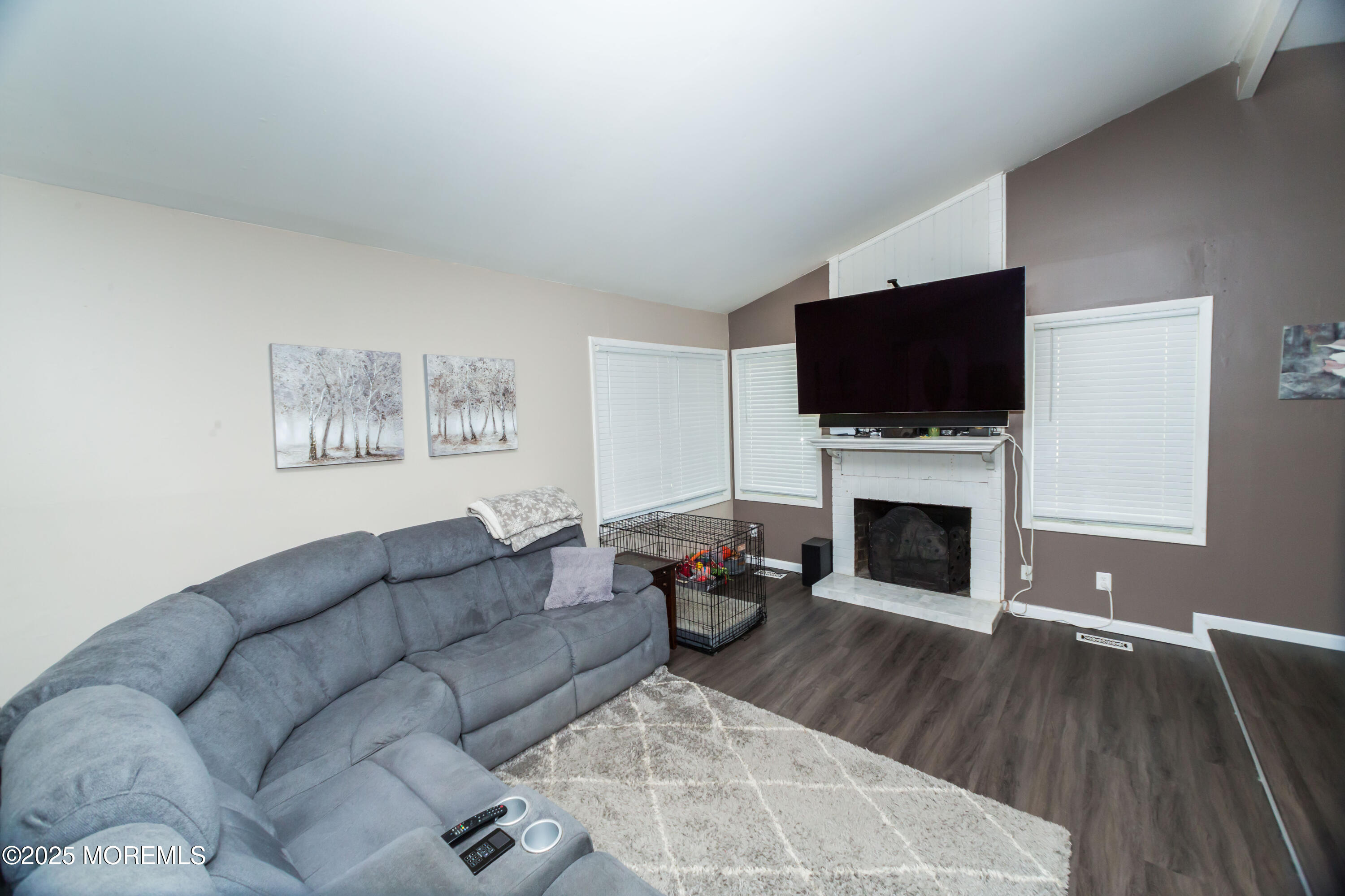 21 Birmingham Drive Jackson, NJ 08527 - Photo 5 of 27 a living room with furniture a flat screen tv and a fireplace