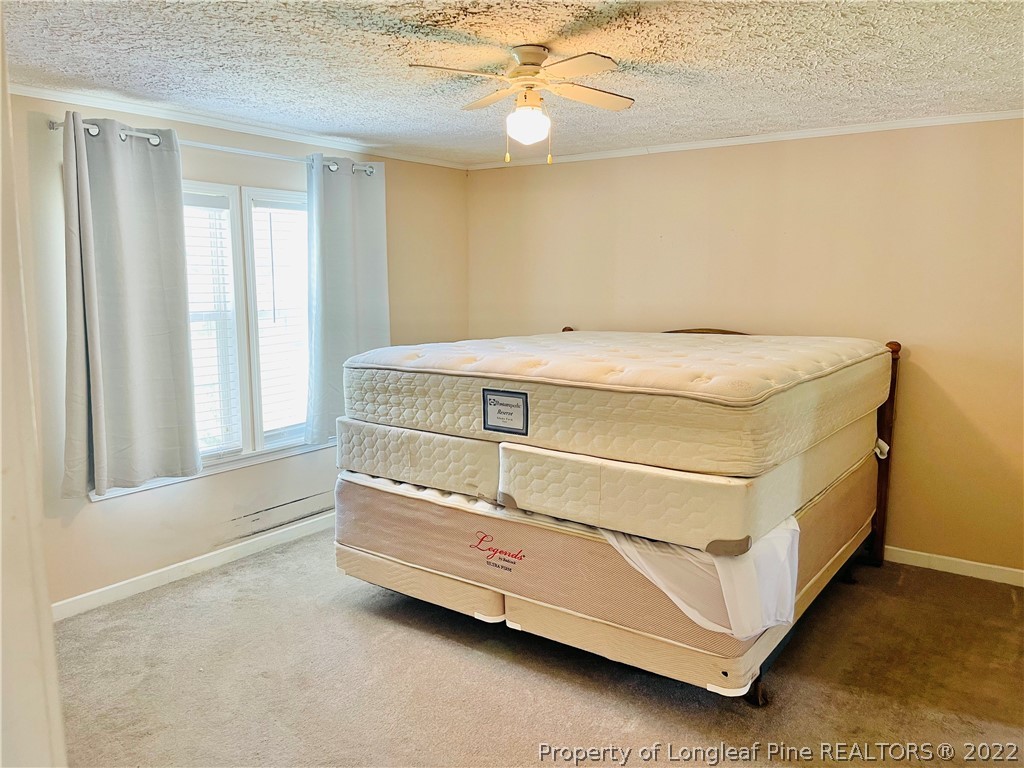 4684 East Raynham Road Fairmont, NC 28340 - Photo 11 of 26 a bed sitting in a room next to a window