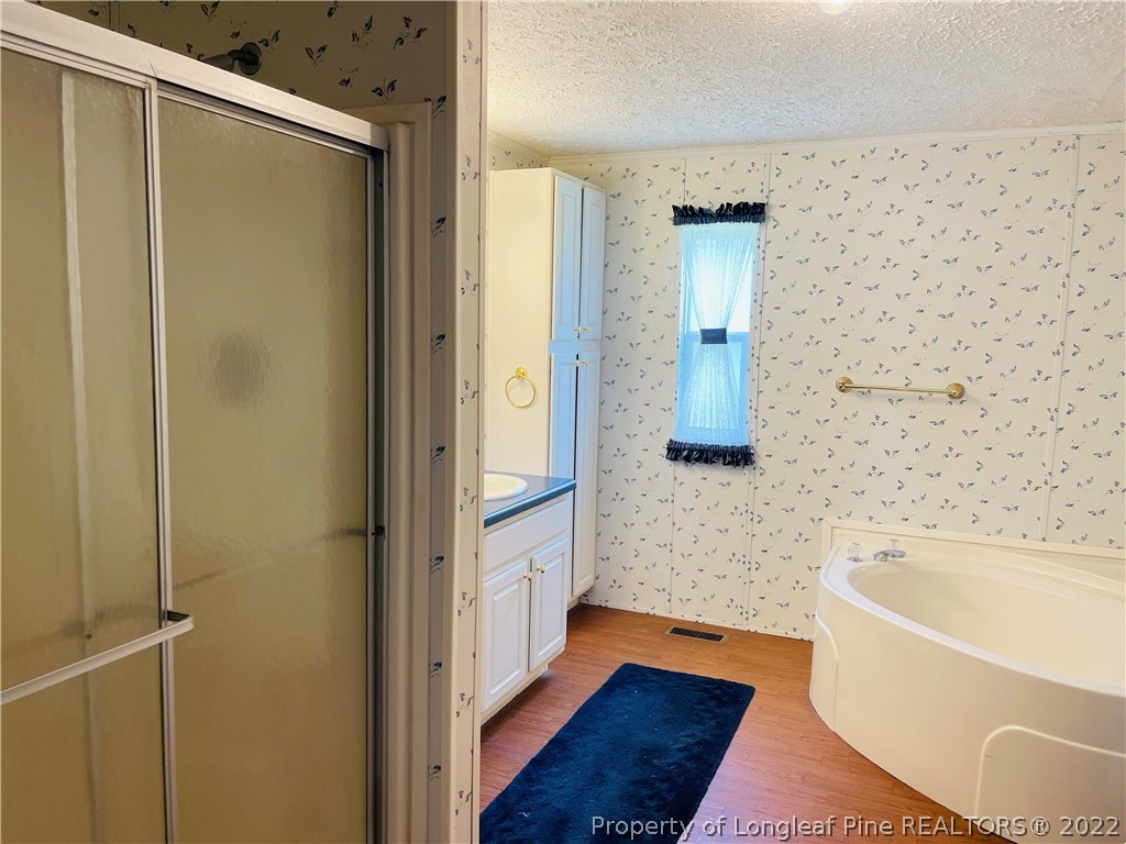 4684 East Raynham Road Fairmont, NC 28340 - Photo 12 of 26 a bathroom with a bathtub and a shower