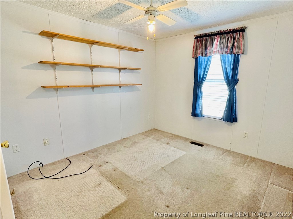 4684 East Raynham Road Fairmont, NC 28340 - Photo 15 of 26 a view of a room with cabinet and windows
