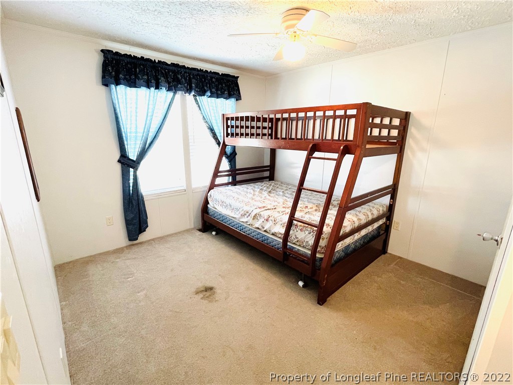 4684 East Raynham Road Fairmont, NC 28340 - Photo 18 of 26 a view of a bedroom with wooden floor