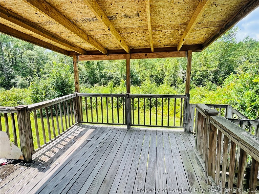 4684 East Raynham Road Fairmont, NC 28340 - Photo 20 of 26 a view of a wooden deck next to a yard
