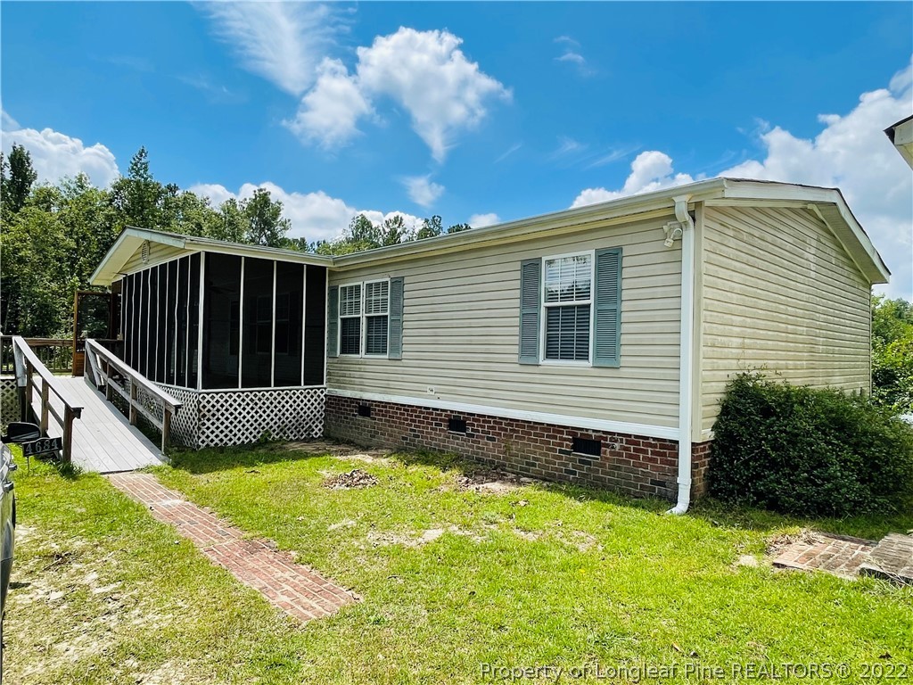 4684 East Raynham Road Fairmont, NC 28340 - Photo 2 of 26 a view of a house with backyard and sitting area