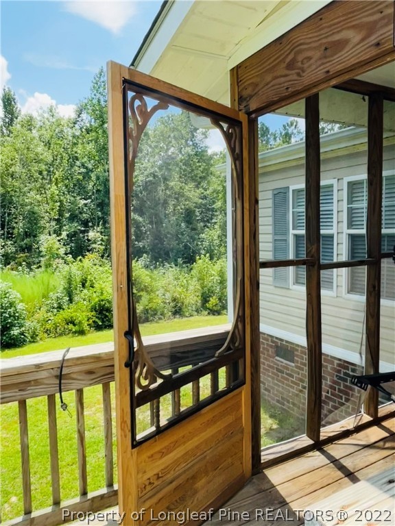 4684 East Raynham Road Fairmont, NC 28340 - Photo 3 of 26 a view of a porch with a large window