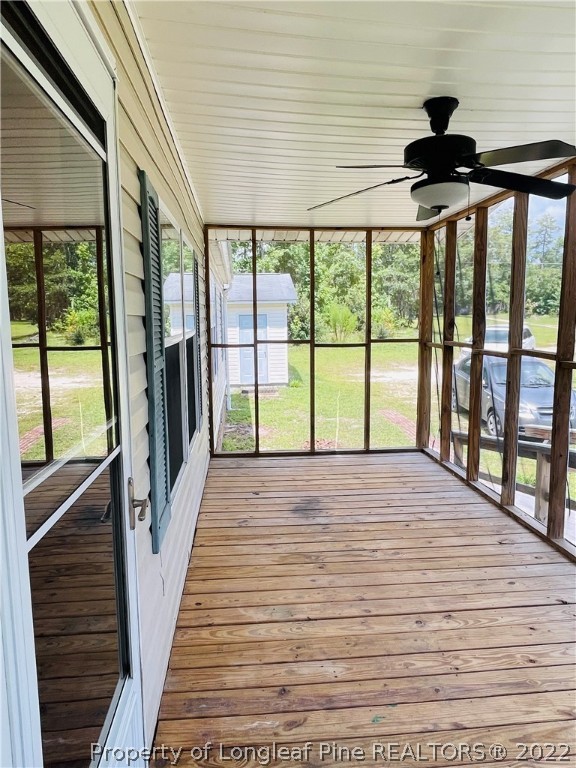 4684 East Raynham Road Fairmont, NC 28340 - Photo 4 of 26 a view of a porch with wooden floor and outdoor space