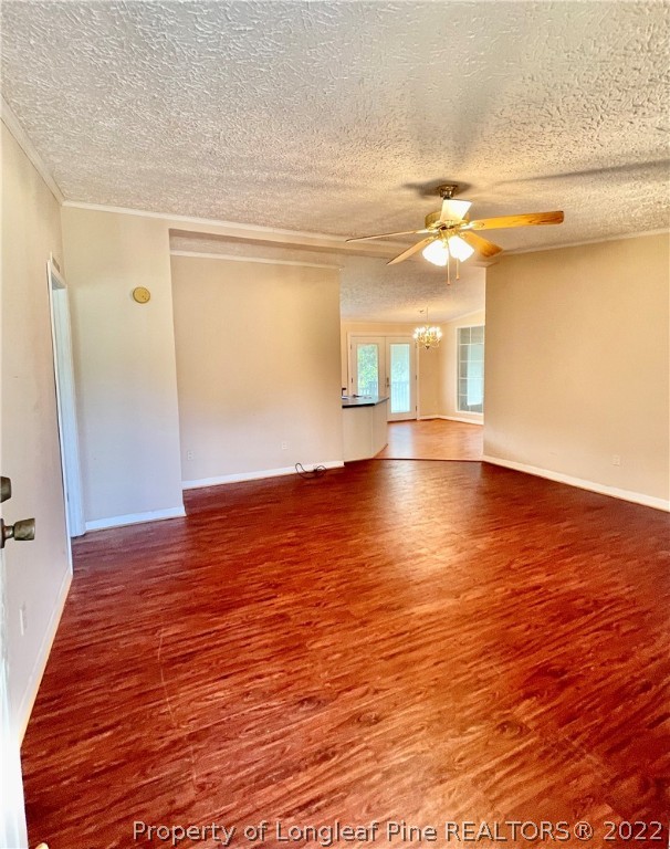 4684 East Raynham Road Fairmont, NC 28340 - Photo 5 of 26 a view of empty room with wooden floor and fan